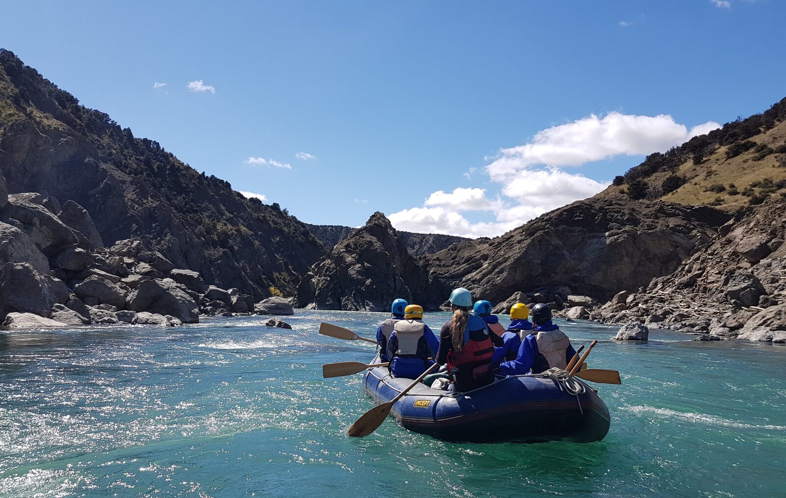 A guided raft of paddlers in an open braided section of the Clarence gorge